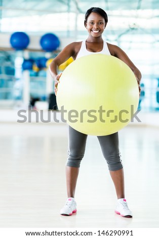 Gym woman doing Pilates and looking very happy