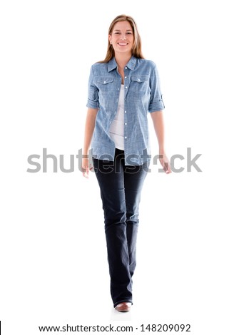 Casual woman walking and smiling - isolated over white background