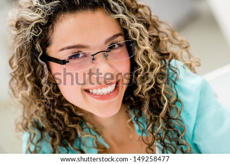 Portrait of a happy woman wearing glasses indoors