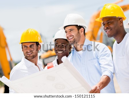 Engineers working on a building site holding a blueprints