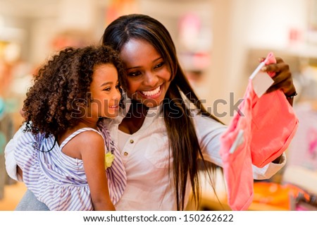 Portrait Of A Mother And Daughter Shopping For Clothes