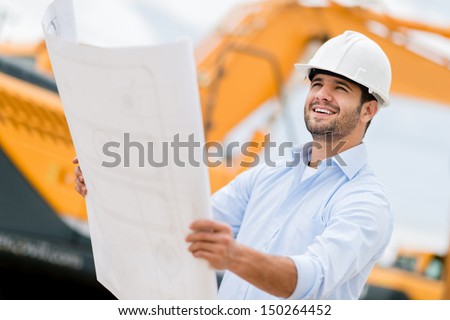 Architect Looking At Blueprints In A Building Site