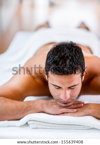 Handsome man looking very relaxed at the spa Handsome man looking very relaxed at the spa
