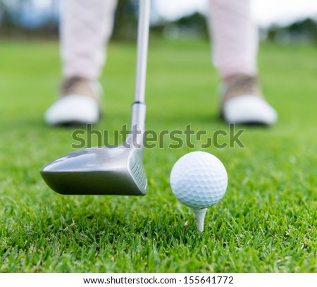 Golf player at the tee box hitting ball