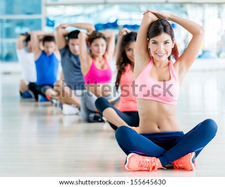 Happy Group Of People Exercising At The Gym