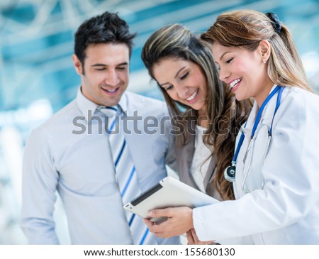 Family doctor with a happy couple at the hospital