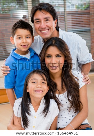 Portrait of a Latin family smiling at home looking very happy