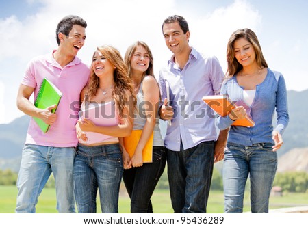Group of students talking a walk outdoors and smiling