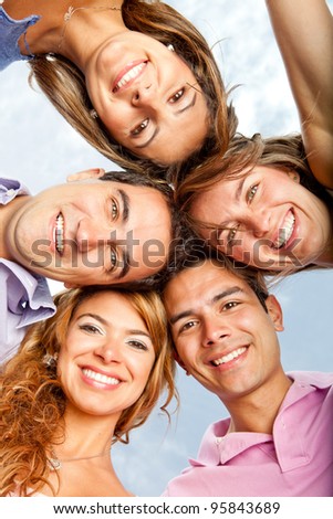 Young people in a group hug and smiling