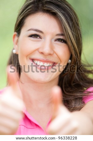 Girl with thumbs up expressing positivity - outdoors