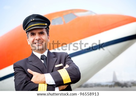 Handsome airplane pilot smiling at the airport