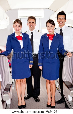 On board friendly team in an airplane smiling