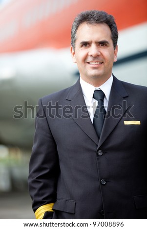 Male pilot in his uniform outdoors at the airport