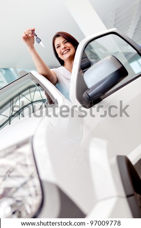 Happy woman buying a car and holding the keys