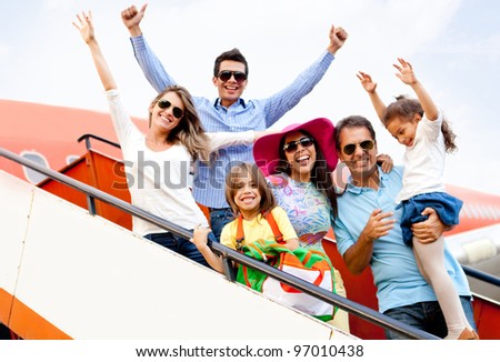 Excited family with arms up traveling by airplane