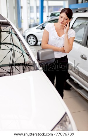 Woman thinking about buying a car but looking lost