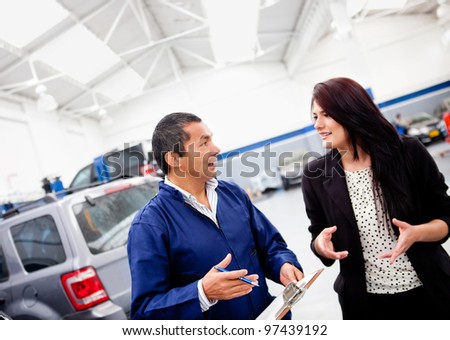 Mechanic explaining to a woman what happened to her car