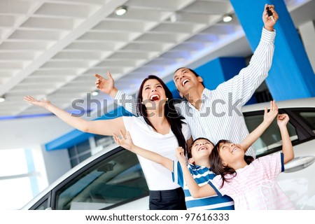 Excited family at the dealer buying a car and celebrating