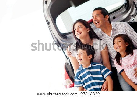 Happy family with their new car smiling