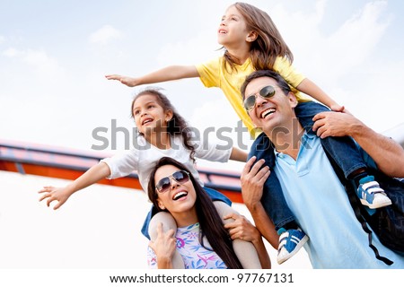 Happy family going on holidays and traveling by airplane