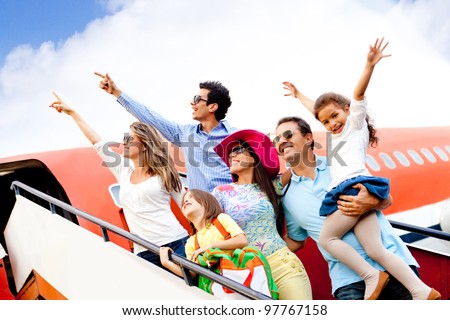 Happy group of people traveling by airplane on their holidays