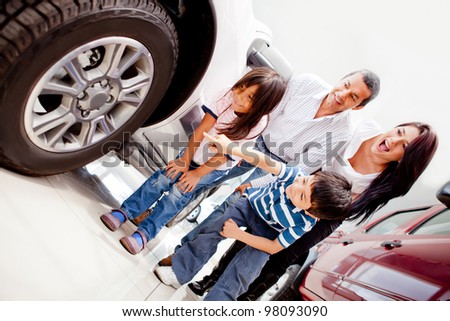Family buying a car and pointing at the wheels