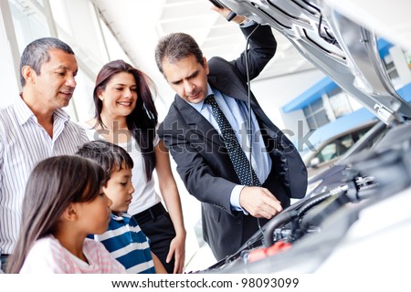 Family buying a car and looking at the engine