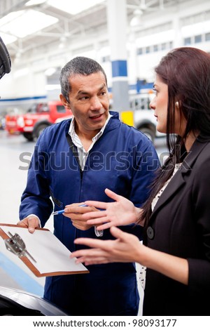 Woman at the mechanic explaining to him the problem with her car