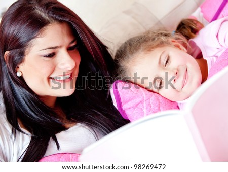 Cute girl reading a bedtime story with her mother