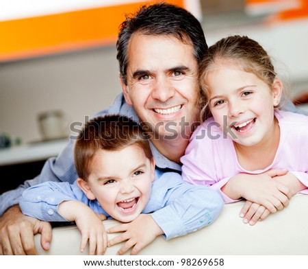 Beautiful portrait of a father with his to kids at home