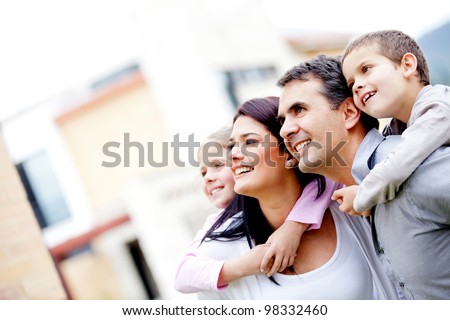 Beautiful family outside their house looking away