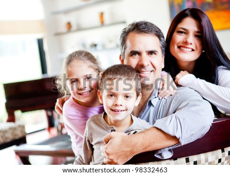 Happy family portrait smiling together at home