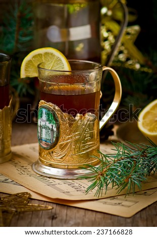 hot black tea with a lemon in vintage glasses against with New Year\'s scenery.selective focus