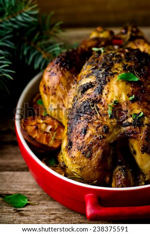 the baked chicken on a rustic background with a New Year\'s decor in vintage style. selective focus.