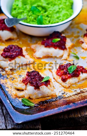 the baked cod with dried tomato and mashed green pea.selective focus