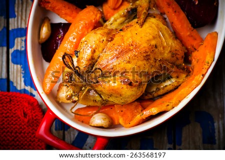 The chicken baked with root crops. top view. selective focus.