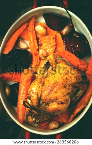 The chicken baked with root crops. top view. selective focus.image is tinted