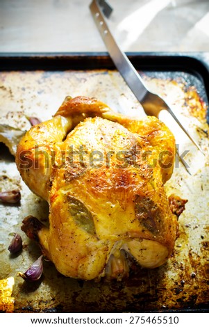 the chicken baked entirely on a baking sheet the top view. style vintage. selective focus