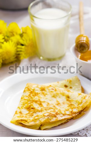 Summer rural breakfast pancakes with honey and milk. style vintage. selective focus