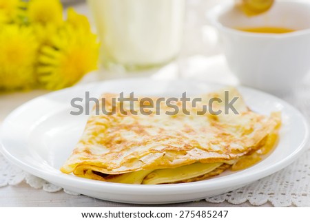 Summer rural breakfast pancakes with honey and milk. style vintage. selective focus