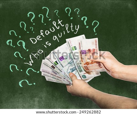 Banknotes in the hands against the background of the drawing with chalk on the Blackboard. currency default