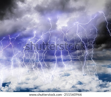 Black clouds in the sky full of lightning in a thunderstorm with a roll of Thunder
