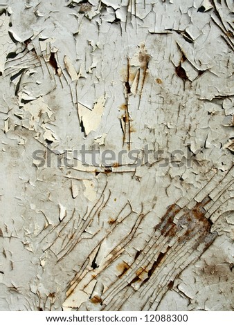 The cracked white paint on an old metallic surface.  Vintage background