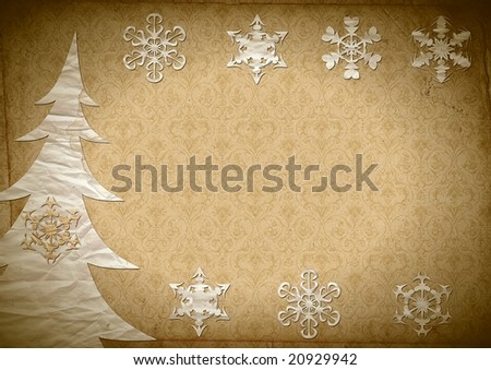 Fur-tree and snowflakes cut out from