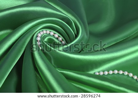 Luxurious deep green satin/silk folded fabric.