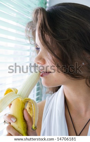 The young woman eat banana