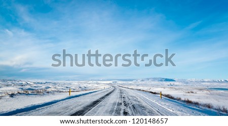 Highway 1 Iceland. Clear road covered in snow and ice under a deep blue sky