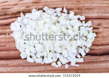 Freshly Diced White Onion. A new pile of chopped white onion on a wooden chopping board