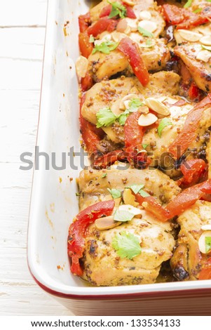 Baked honey mustard chicken thighs with roasted red bell peppers, toasted almonds and parsley