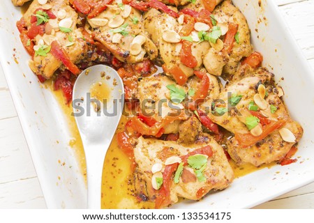 Baked honey mustard chicken thighs with roasted red bell peppers, toasted almonds and parsley